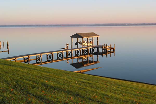 Dock and boat house featuring preserved wood